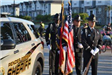 Holding flags by Sheriff Cruiser