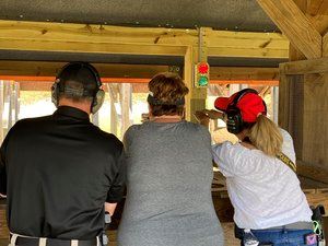 Three people looking down the range