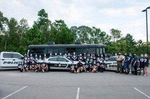 Runners next to Law Enforcement vehicles